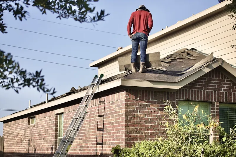 Professional roofer working on a residential roof in Sudley Mountain Estates